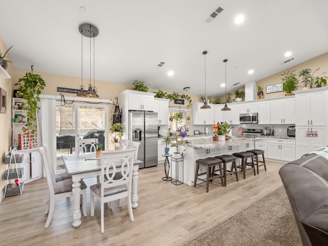 40023 Woodsong Way, Oakhurst, CA 93644 - dining space featuring vaulted ceiling, recessed lighting, visible vents, and light wood-style floors