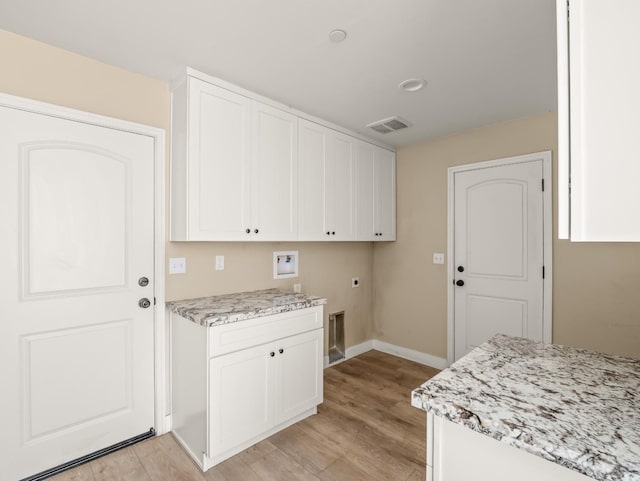 40023 Woodsong Way, Oakhurst, CA 93644 - clothes washing area with washer hookup, cabinet space, visible vents, hookup for an electric dryer, and light wood-type flooring