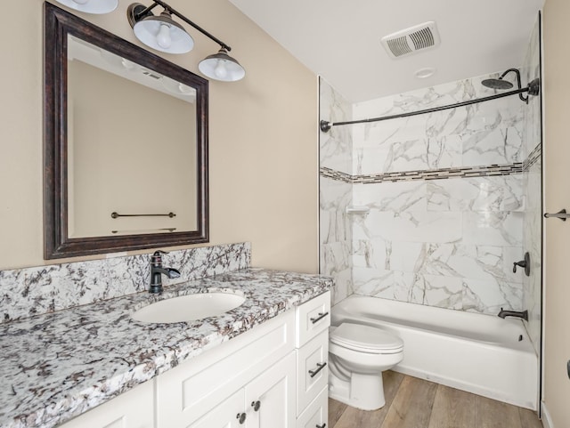 40023 Woodsong Way, Oakhurst, CA 93644 - full bathroom featuring visible vents, toilet, wood finished floors, vanity, and shower / bathing tub combination