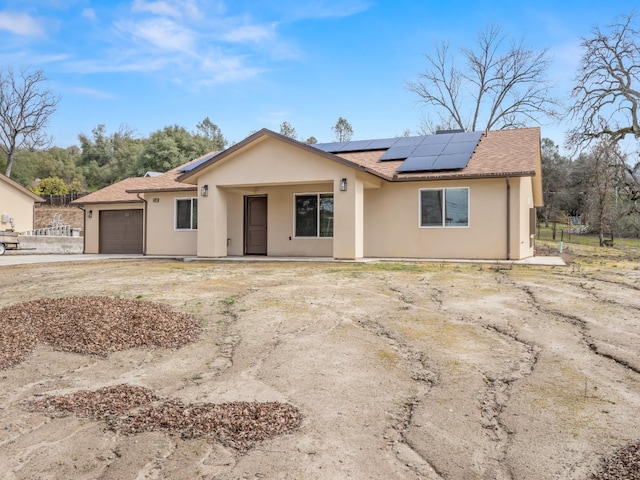 40023 Woodsong Way, Oakhurst, CA 93644 - ranch-style house featuring solar panels, roof with shingles, an attached garage, and stucco siding