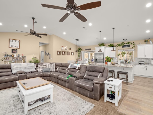 40023 Woodsong Way, Oakhurst, CA 93644 - living room featuring lofted ceiling, visible vents, light wood-style flooring, and recessed lighting