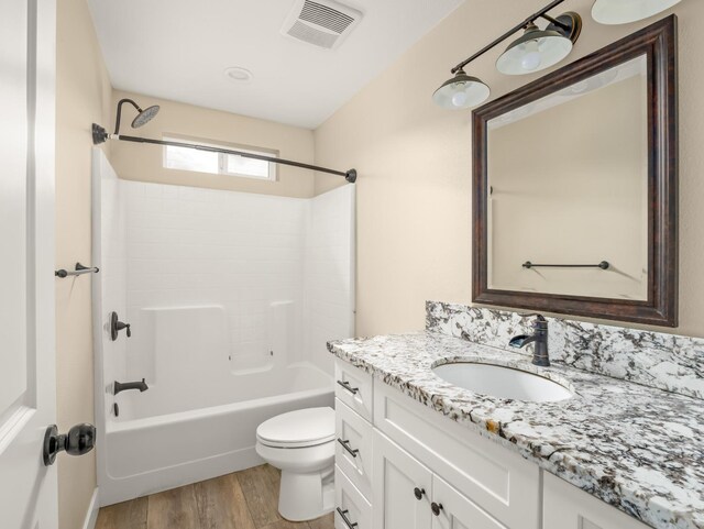 40023 Woodsong Way, Oakhurst, CA 93644 - full bathroom with visible vents, toilet, wood finished floors, bathtub / shower combination, and vanity