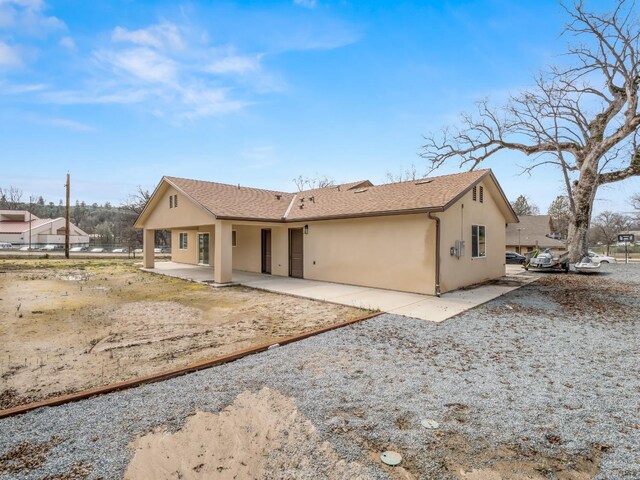 40023 Woodsong Way, Oakhurst, CA 93644 - view of front of home with roof with shingles, a patio, and stucco siding
