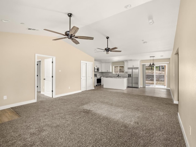40023 Woodsong Way, Oakhurst, CA 93644 - unfurnished living room with carpet, visible vents, vaulted ceiling, a sink, and baseboards