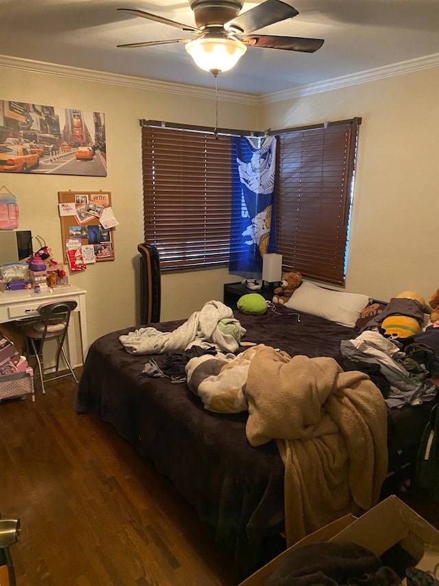 bedroom featuring crown molding, ceiling fan, and wood finished floors