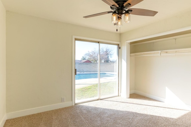 interior space with access to outside, a closet, baseboards, and carpet flooring