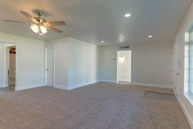 carpeted spare room featuring baseboards, visible vents, ceiling fan, and recessed lighting