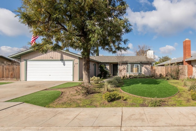 ranch-style home featuring a garage, driveway, a front yard, and fence