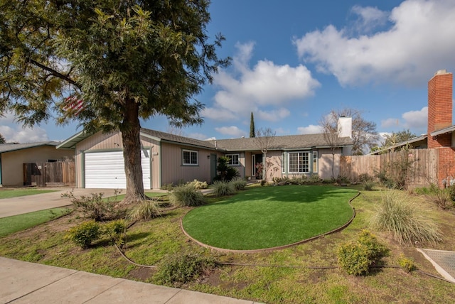 ranch-style home with a front lawn, fence, driveway, and an attached garage