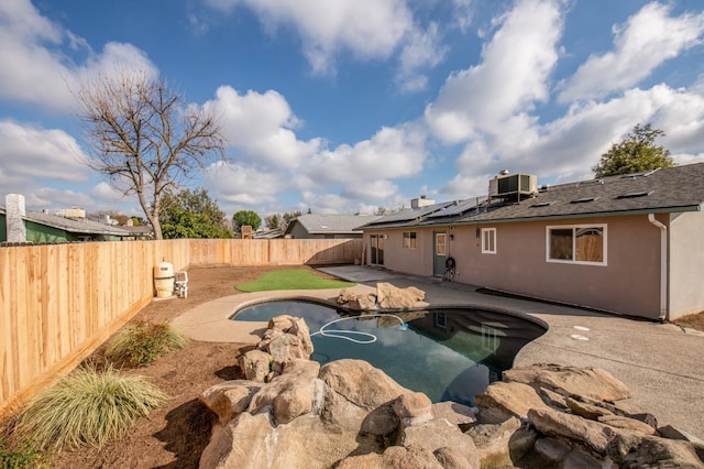 view of pool featuring a fenced backyard, central AC unit, a fenced in pool, and a patio