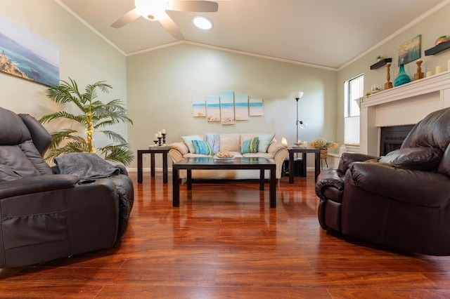 living room featuring ornamental molding, vaulted ceiling, and wood finished floors