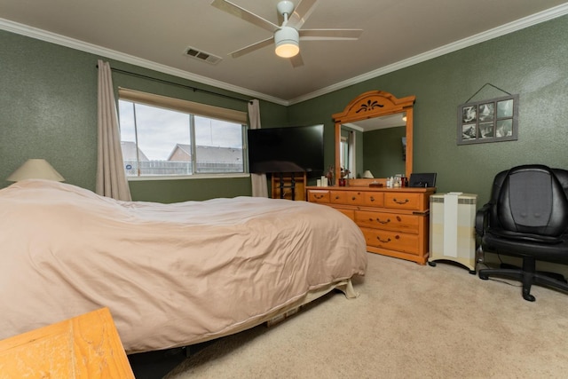 bedroom with crown molding, ceiling fan, visible vents, and light colored carpet