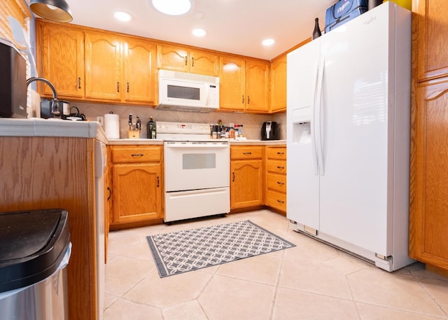 kitchen featuring recessed lighting, light countertops, backsplash, light tile patterned flooring, and white appliances