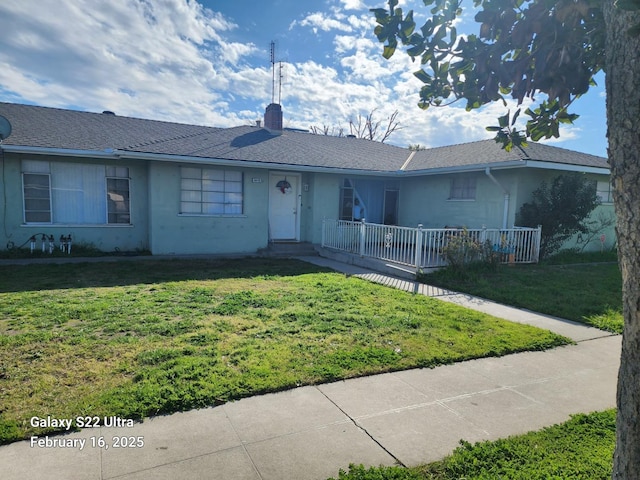 single story home with covered porch, a front lawn, a chimney, and stucco siding