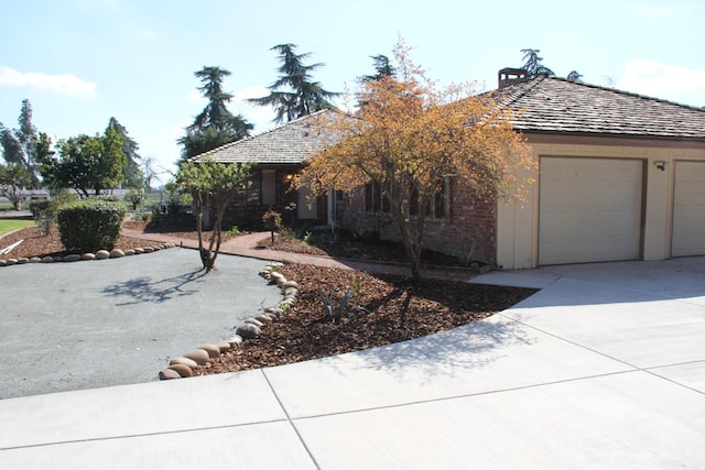 view of front of property featuring a garage and concrete driveway