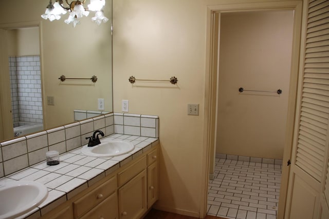 bathroom with double vanity, baseboards, backsplash, and a sink