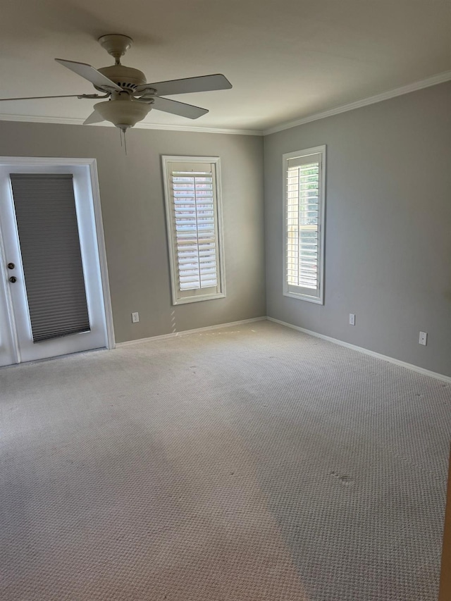 unfurnished room featuring ornamental molding, carpet flooring, ceiling fan, and baseboards