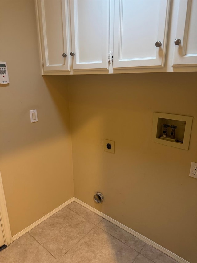 laundry room with cabinet space, light tile patterned floors, washer hookup, and electric dryer hookup