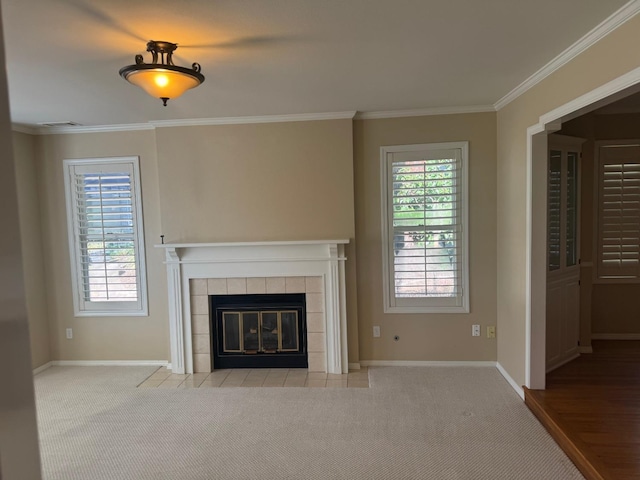 unfurnished living room featuring ornamental molding, carpet flooring, plenty of natural light, and a fireplace