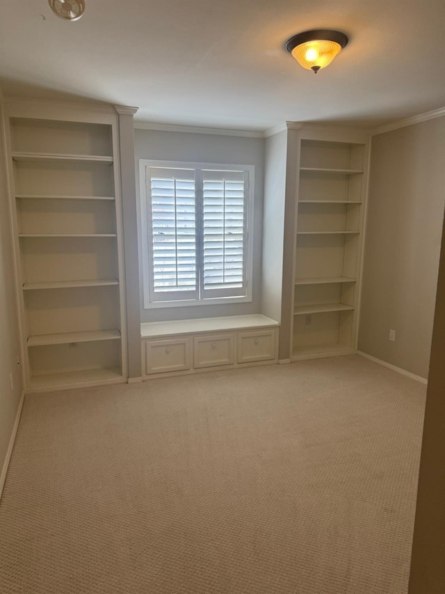 unfurnished bedroom featuring light carpet, crown molding, and baseboards