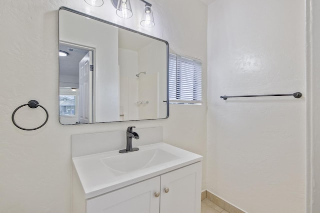 bathroom with vanity and baseboards