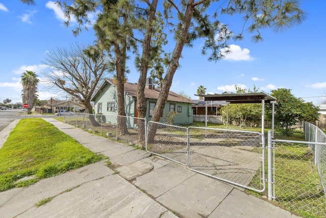 bungalow with a fenced front yard and a gate