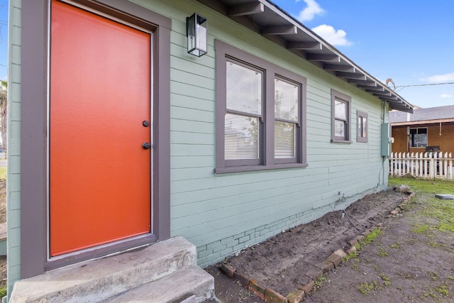 doorway to property with fence