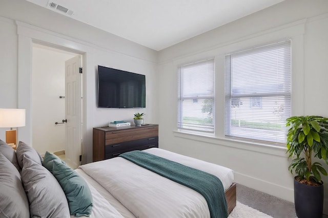 bedroom featuring visible vents and baseboards