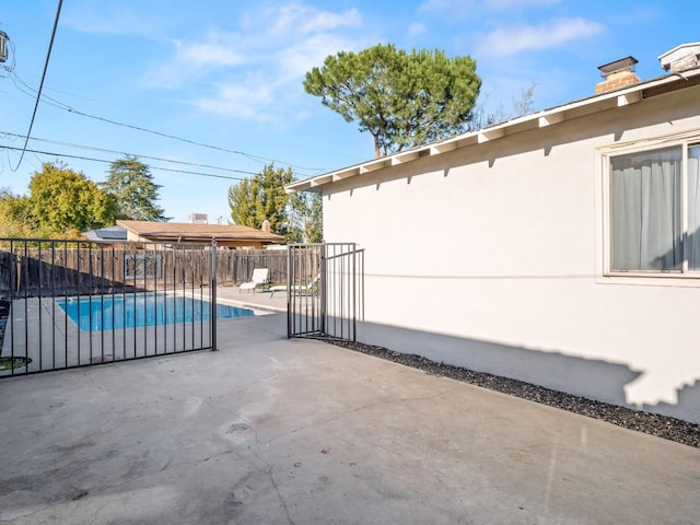 view of patio / terrace featuring fence and a fenced in pool