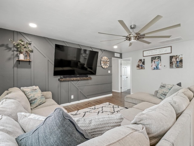 living area featuring a ceiling fan, recessed lighting, visible vents, and wood finished floors