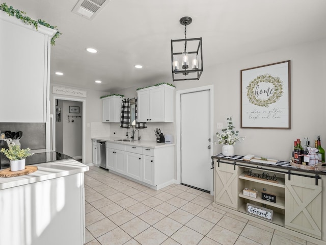 kitchen featuring visible vents, a sink, dishwasher, and light tile patterned floors