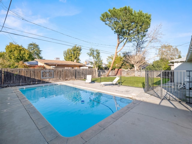 view of pool featuring a yard, a fenced backyard, a fenced in pool, and a patio