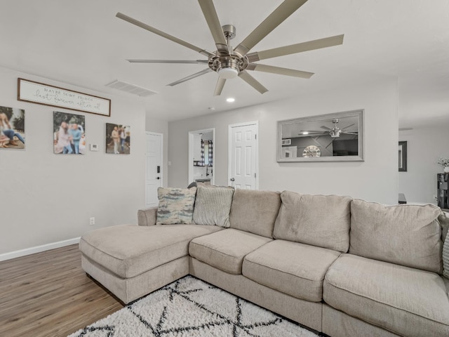 living room featuring visible vents, baseboards, ceiling fan, wood finished floors, and recessed lighting