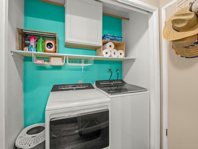 laundry room with washing machine and dryer and cabinet space