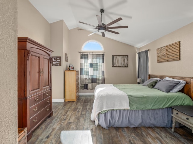 bedroom with vaulted ceiling, ceiling fan, dark wood finished floors, and baseboards