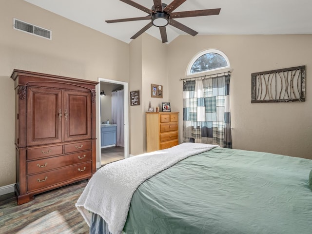 bedroom featuring visible vents, connected bathroom, lofted ceiling, ceiling fan, and wood finished floors