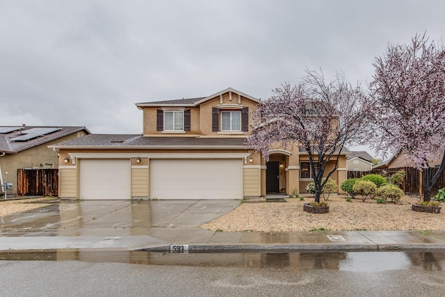 view of front of house with driveway and fence