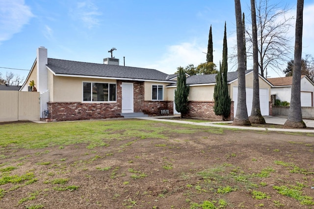 ranch-style home with brick siding, a chimney, a front lawn, and fence