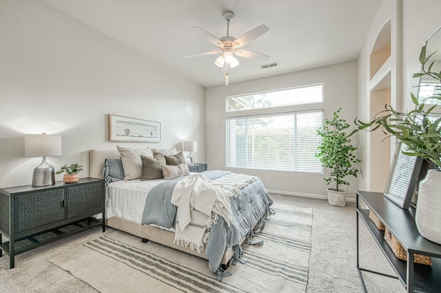 carpeted bedroom featuring lofted ceiling, visible vents, ceiling fan, and baseboards