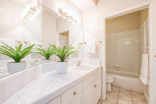 bathroom with vanity, tile patterned flooring, and toilet