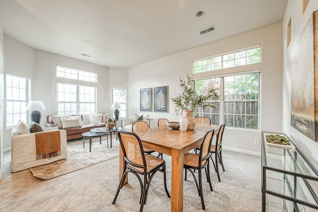 dining area featuring carpet floors, visible vents, and baseboards