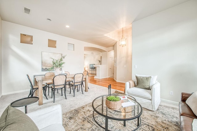 interior space featuring visible vents, arched walkways, baseboards, and recessed lighting