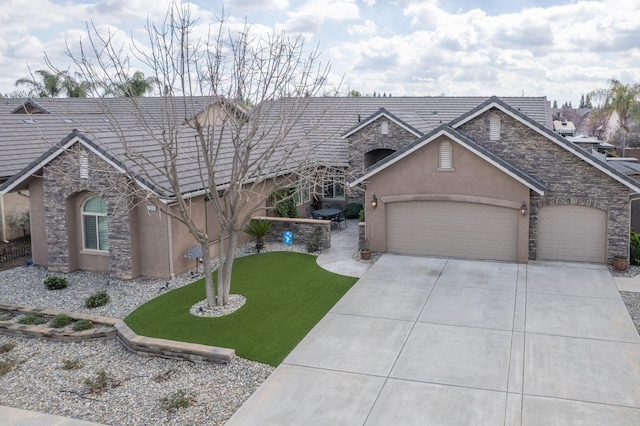 view of front facade with a garage, stone siding, driveway, and stucco siding