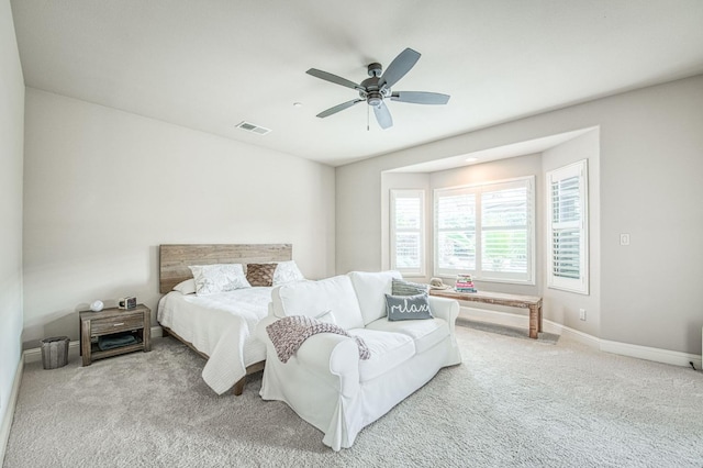 carpeted bedroom featuring baseboards, visible vents, and a ceiling fan