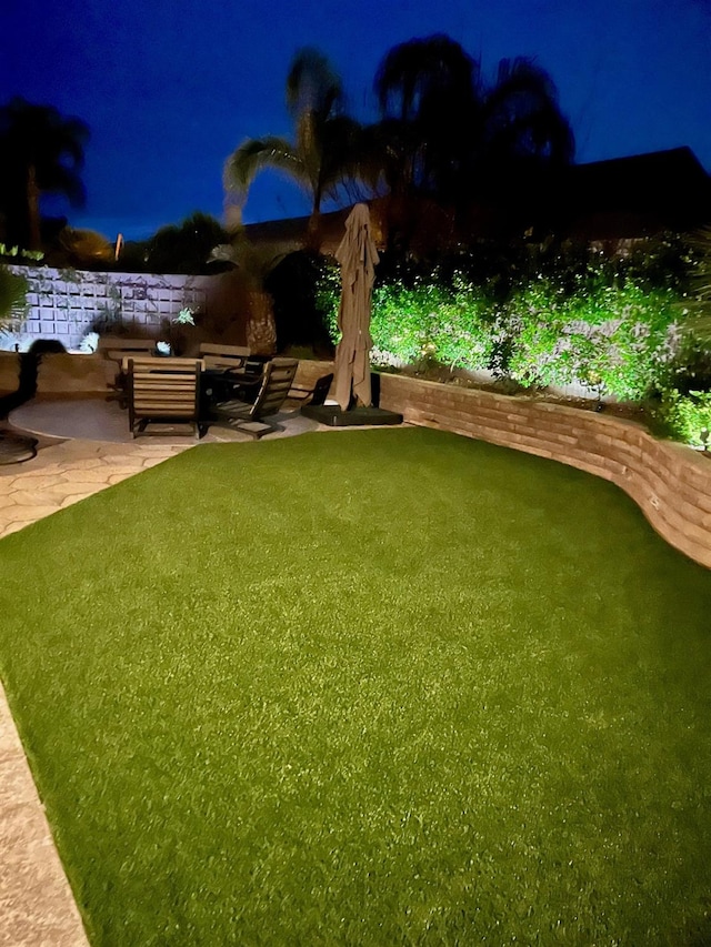 yard at twilight with a patio area and an outdoor living space