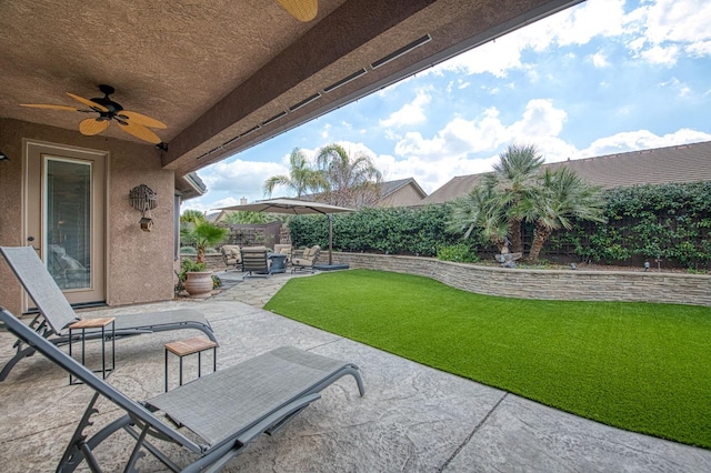 view of patio with ceiling fan, outdoor lounge area, and a fenced backyard