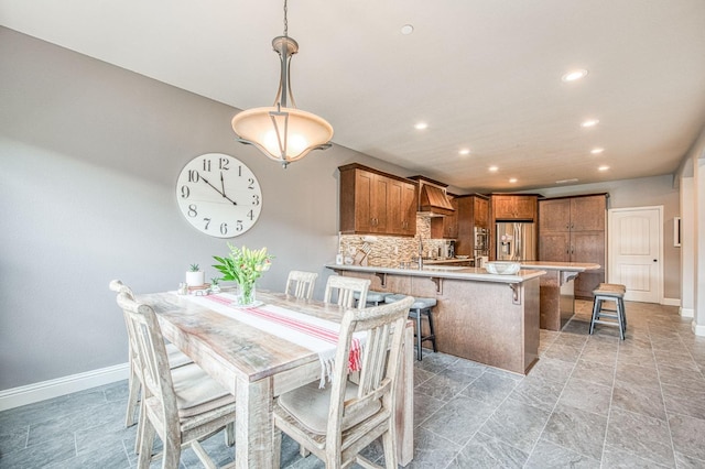 dining room with recessed lighting and baseboards