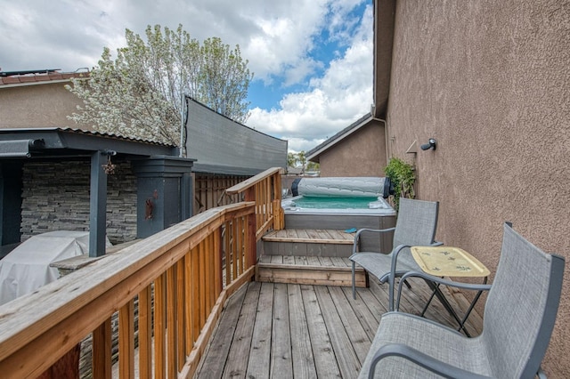 deck featuring a hot tub