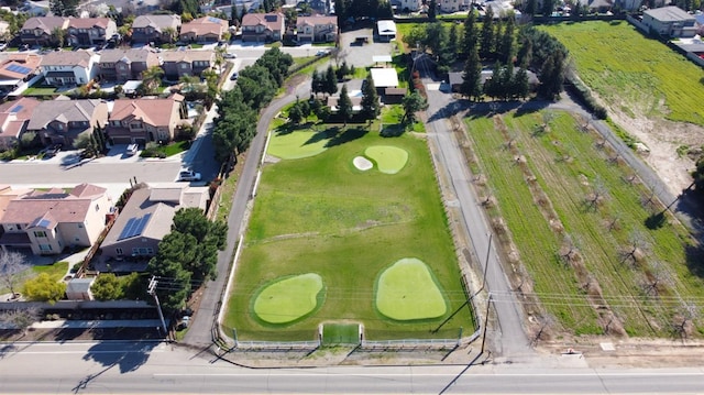 birds eye view of property featuring view of golf course and a residential view