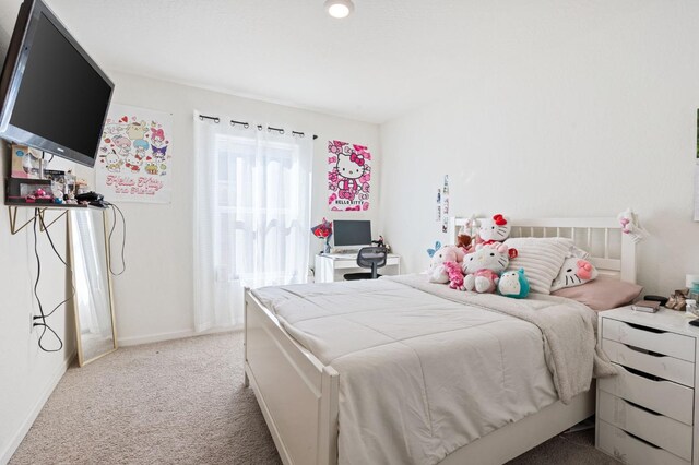 carpeted bedroom featuring baseboards